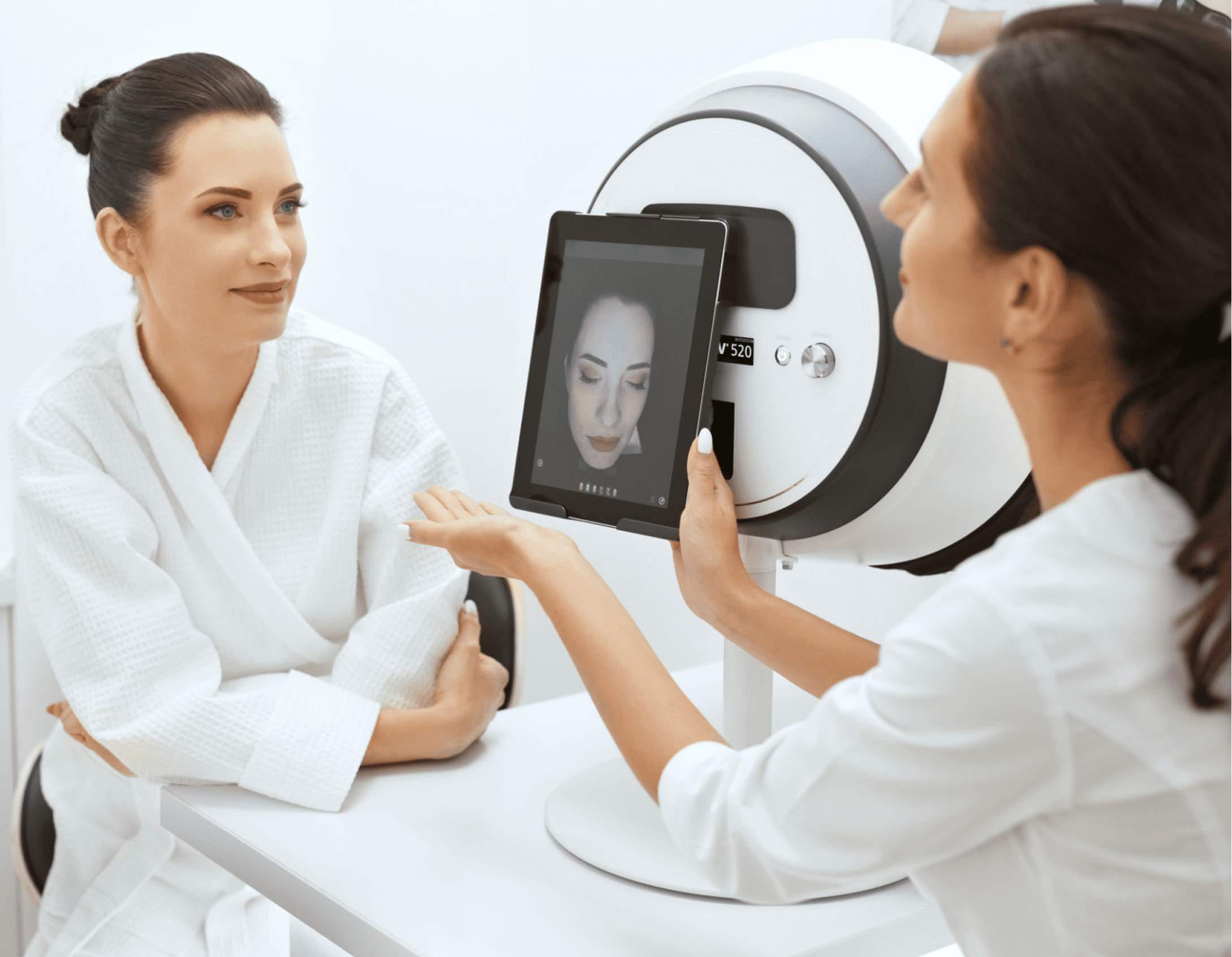Skin analysis consultation with digital tablet display.