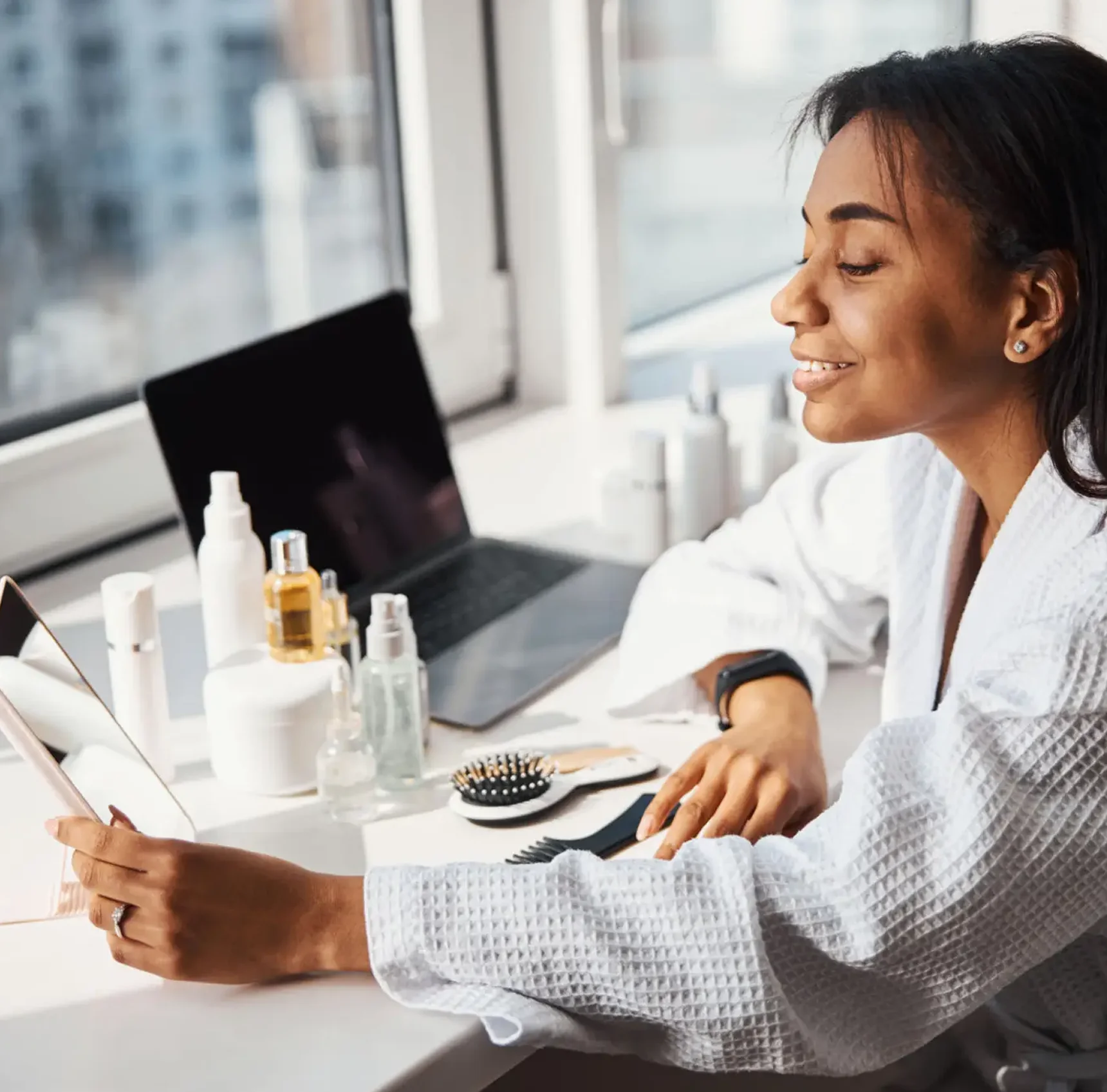 Woman smiling while using a tablet.