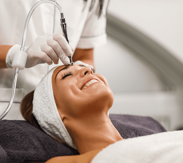 Woman receiving a facial treatment at spa.