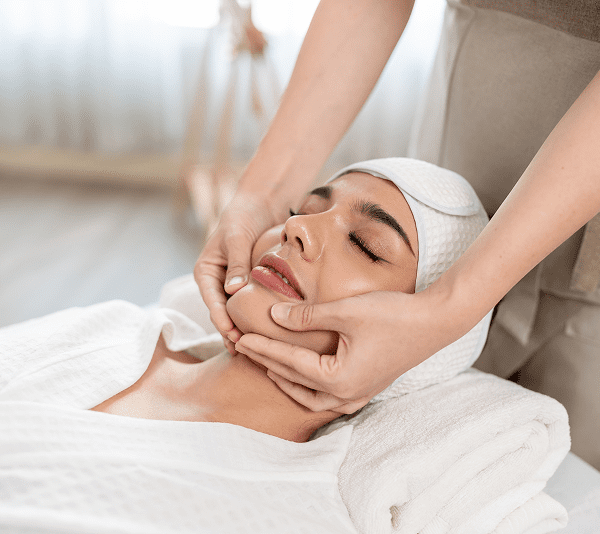Facial massage in a spa setting.